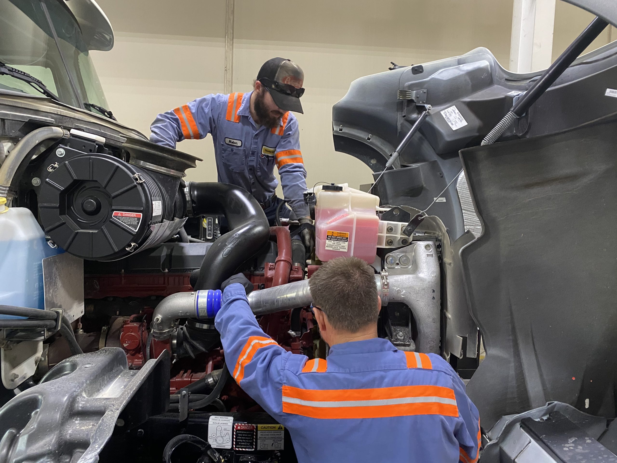 Mechanics working on a truck repair